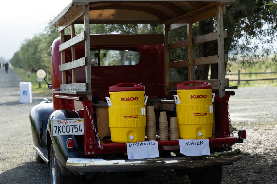Water and electrolytes served from a vintage red truck